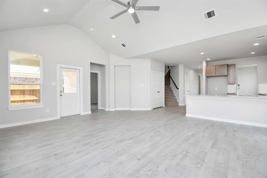 Take another glimpse into the heart of the home with this additional view of the family room—a sprawling space ready to accommodate all your gatherings. Photo shown is example of completed home with similar plan. Actual colors and selections may vary.