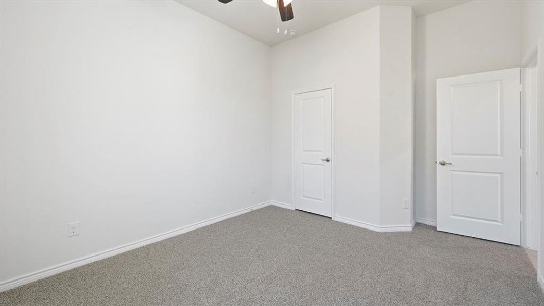 Spare room featuring carpet and ceiling fan Spare room featuring carpet and ceiling fan