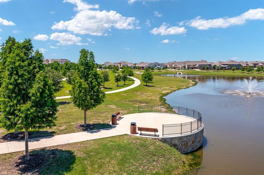 Dock area with a water view and a yard