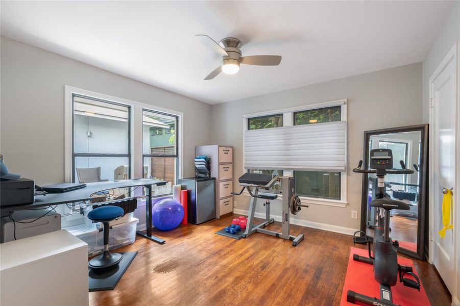 An adaptable interior space featuring hardwood floors and a ceiling fan, perfect for a home office or gym. An adaptable interior space featuring hardwood floors and a ceiling fan, perfect for a home office or gym.