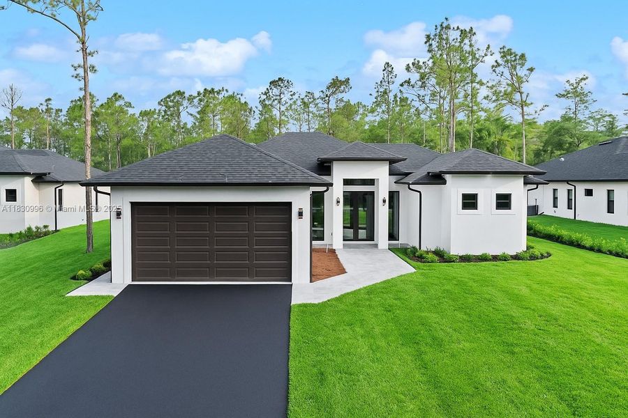 Front exterior of a new home in , Naples, FL, highlighting curb appeal (Image 19).