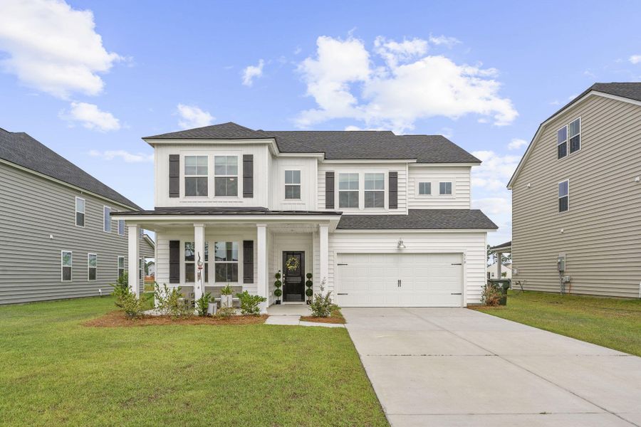 Front exterior of a new home in Lindera Preserve at Cane Bay Plantation, Summerville, SC, highlighting curb appeal (Image 2). Front exterior of a new home in Lindera Preserve at Cane Bay Plantation, Summerville, SC, highlighting curb appeal (Image 2).