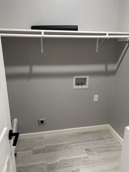 Laundry area with hookup for an electric dryer, hookup for a washing machine, and light wood finished floors Laundry area with hookup for an electric dryer, hookup for a washing machine, and light wood finished floors