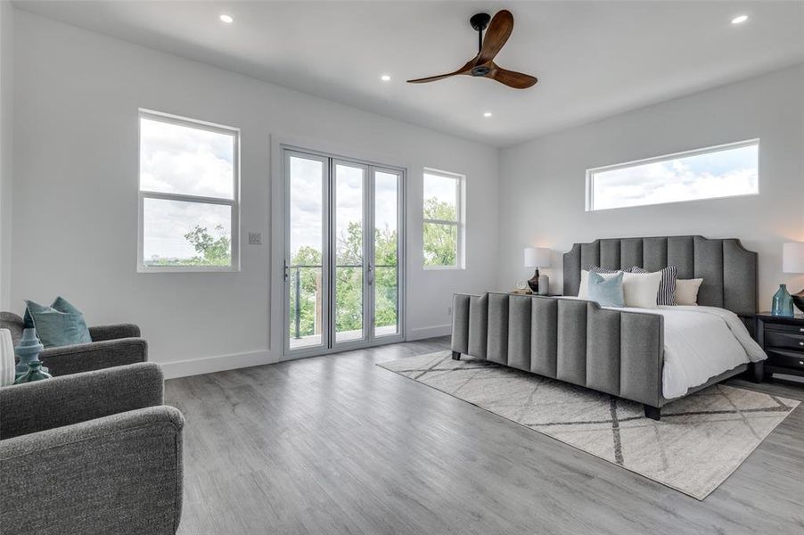 Bedroom featuring access to exterior, light hardwood / wood-style floors, and ceiling fan