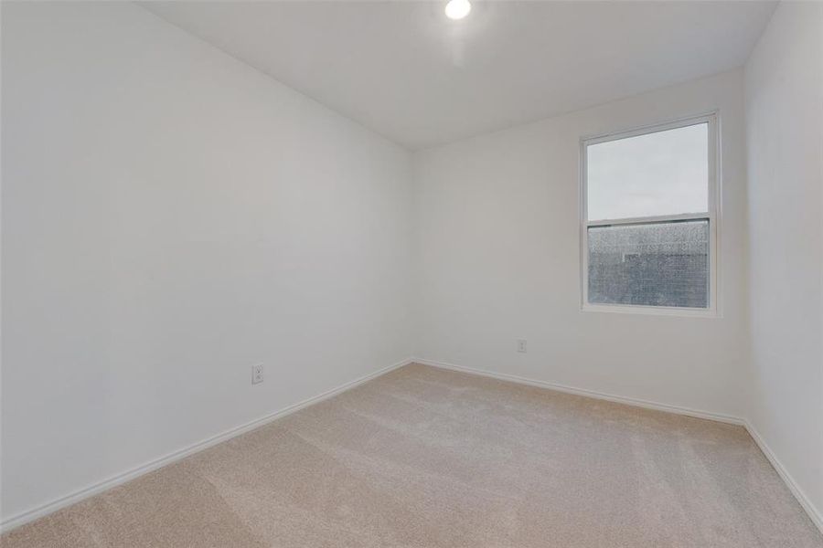 Unfurnished room featuring light colored carpet