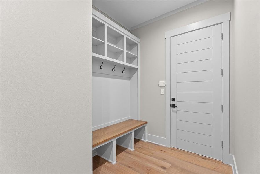 Mudroom featuring light wood-type flooring and baseboards