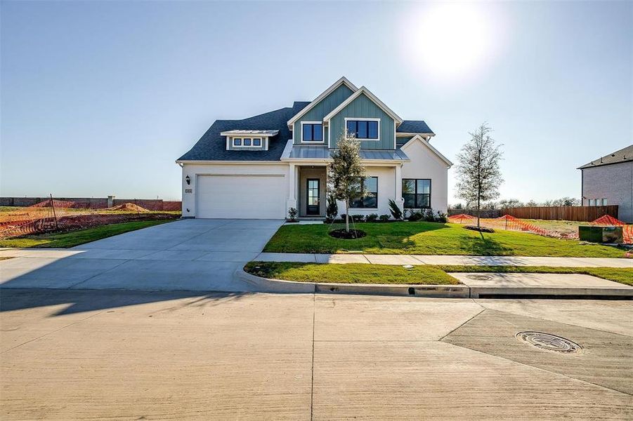 View of front of property with a front yard and a garage View of front of property with a front yard and a garage