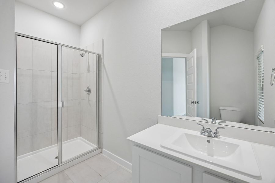 Bathroom in the Masters home plan by Trophy Signature Homes – REPRESENTATIVE PHOTO