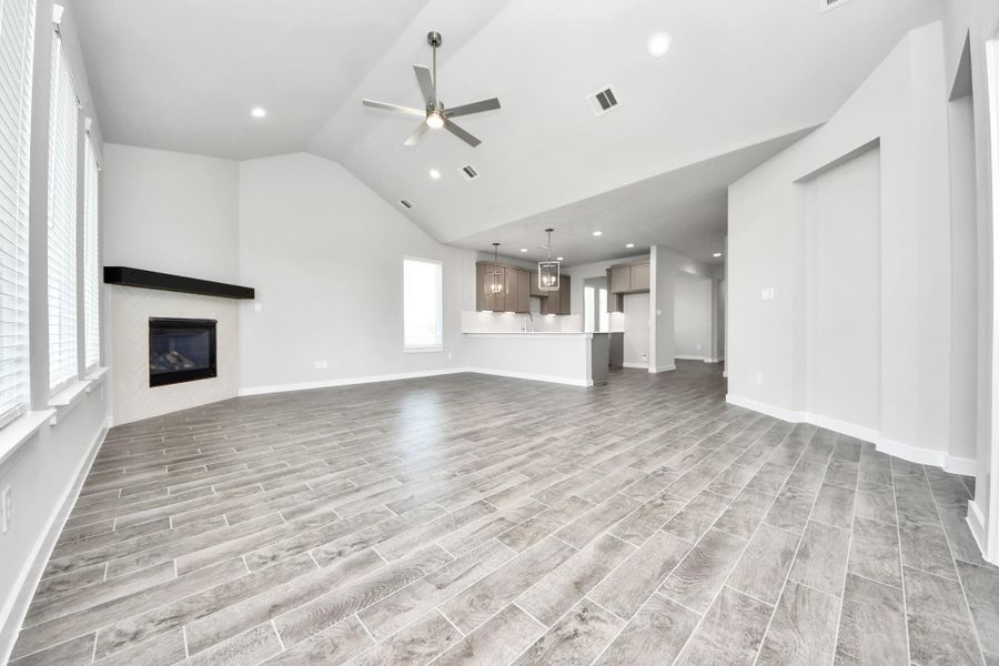 Family room flooded with natural light through the expansive windows. The premium tile flooring adds a touch of luxury to the space, creating the perfect setting for relaxing moments and cherished gatherings with loved ones. Sample photo of completed home with similar floor plan. Actual colors and selections may vary. Family room flooded with natural light through the expansive windows. The premium tile flooring adds a touch of luxury to the space, creating the perfect setting for relaxing moments and cherished gatherings with loved ones. Sample photo of completed home with similar floor plan. Actual colors and selections may vary.
