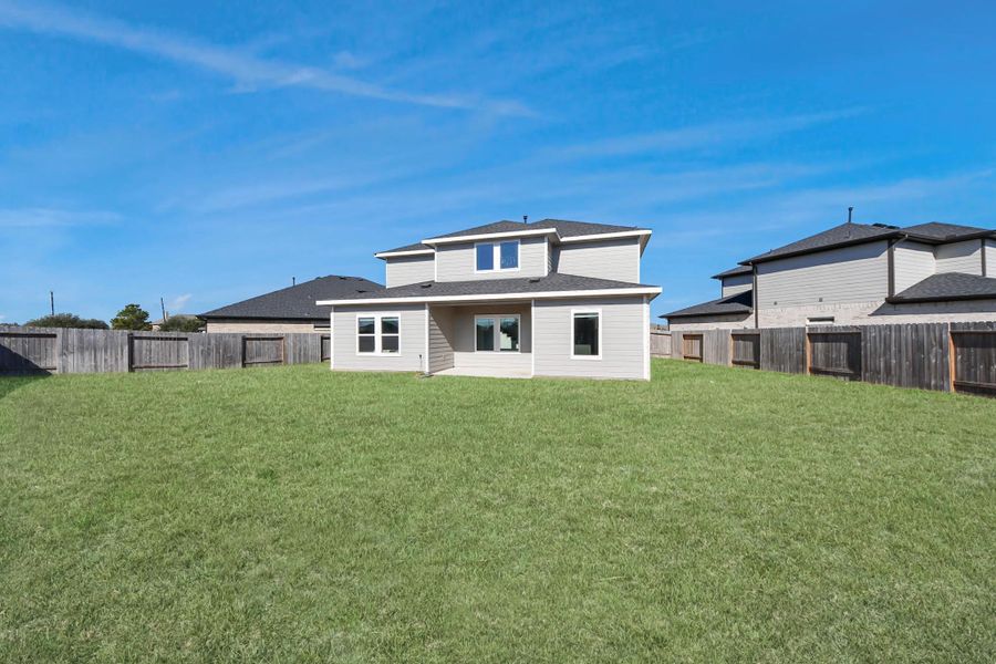 The spacious fenced yard, perfect for future pool oasis, gardening, or a playground.