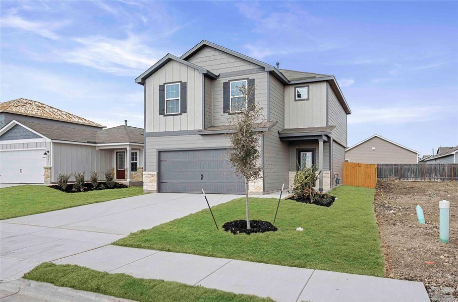 A newly constructed modern dwelling features an attached garage and well-maintained front landscaping. A newly constructed modern dwelling features an attached garage and well-maintained front landscaping.