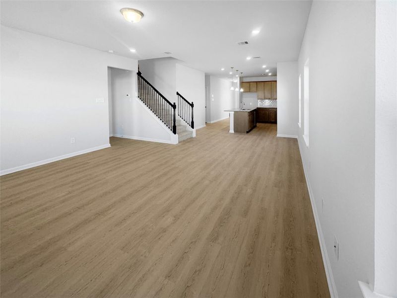 The Waring III- Family Room into Kitchen. Under construction, options, upgrades and colors will vary.