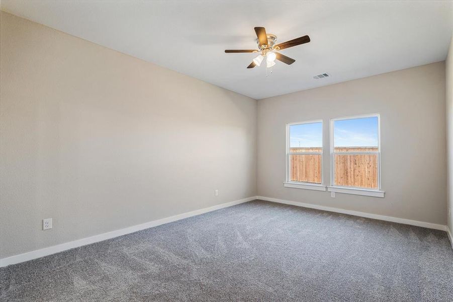 Master bedroom with ceiling fan and carpet floors Master bedroom with ceiling fan and carpet floors