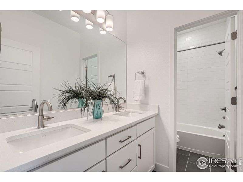 Divided main hall bath with double sinks.