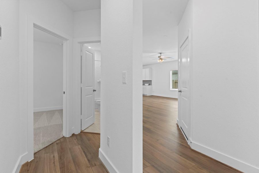 Hallway has the carefree upgraded wood look vinyl plank flooring and clean architectural flow. **Image Representative of Plan Only and May Vary as Built**.