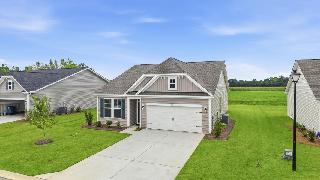 Front exterior of a new home in Edgefield, Loris, SC, highlighting curb appeal (Image 16). Front exterior of a new home in Edgefield, Loris, SC, highlighting curb appeal (Image 16).