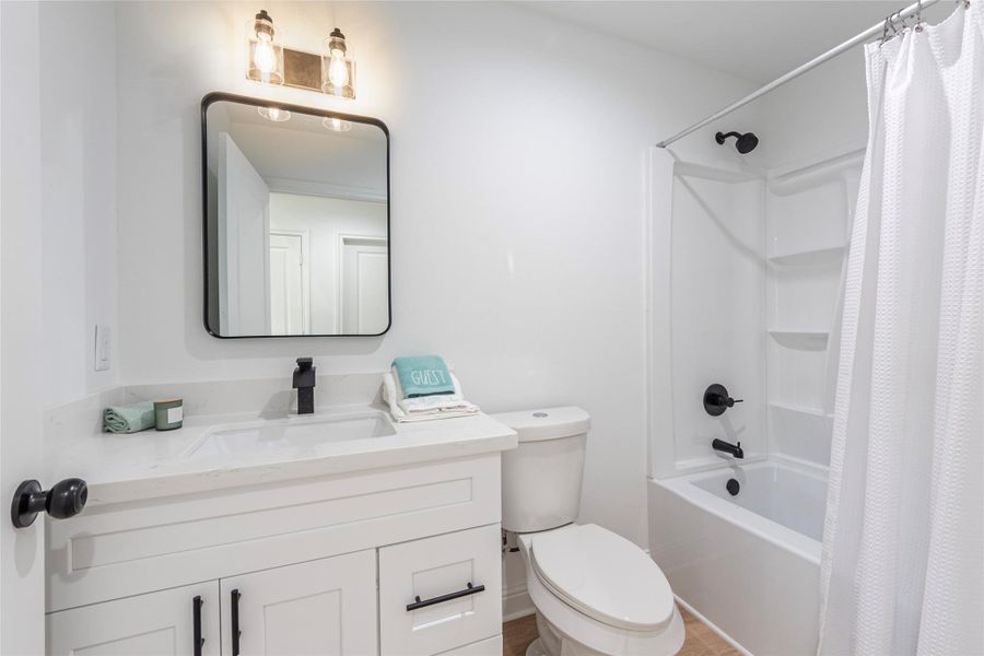 Spare bath with Quartz counter tops, undermount sink, large vanity with storage and shower/tub combination.