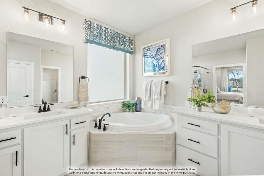 Master bathroom with dual vanities, soaking tub, and large window between two mirrors Master bathroom with dual vanities, soaking tub, and large window between two mirrors
