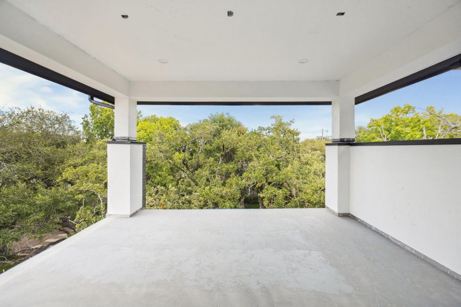 Covered Roof-Top Terrace with Westcoat ALX Waterproofing System with Decorative Overlay Finish. There is a glass railing, on the north and west side of the terrace and a stucco wall on the east side.  Construction as of September 29th, 2025.
