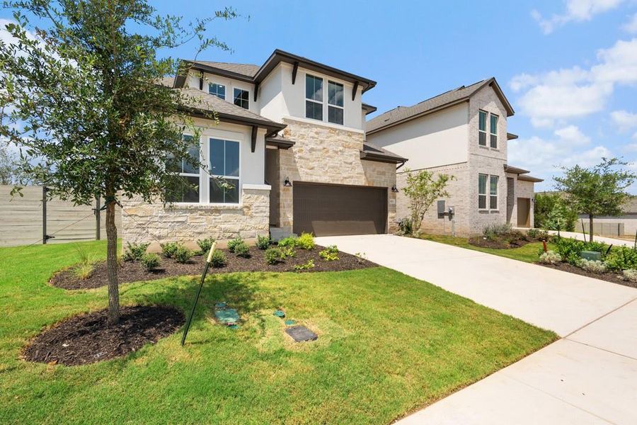 Front exterior of a new home in Wolf Ranch, Georgetown, TX, highlighting curb appeal (Image 22).