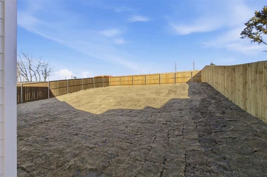 View of fenced backyard