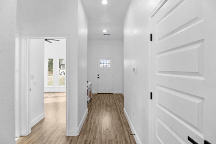 Corridor featuring light wood-style floors and recessed lighting Corridor featuring light wood-style floors and recessed lighting