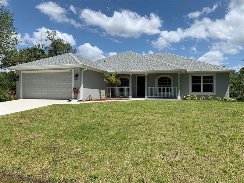 Front exterior of a new home in Port Charlotte, Port Charlotte, FL, highlighting curb appeal (Image 2). Front exterior of a new home in Port Charlotte, Port Charlotte, FL, highlighting curb appeal (Image 2).