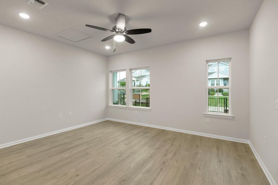 Spacious room with light-colored flooring, recessed lighting, and a ceiling fan
