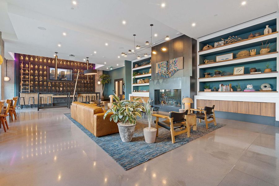 Lobby area equipped with lounge seating, co-working spaces and a fireplace.