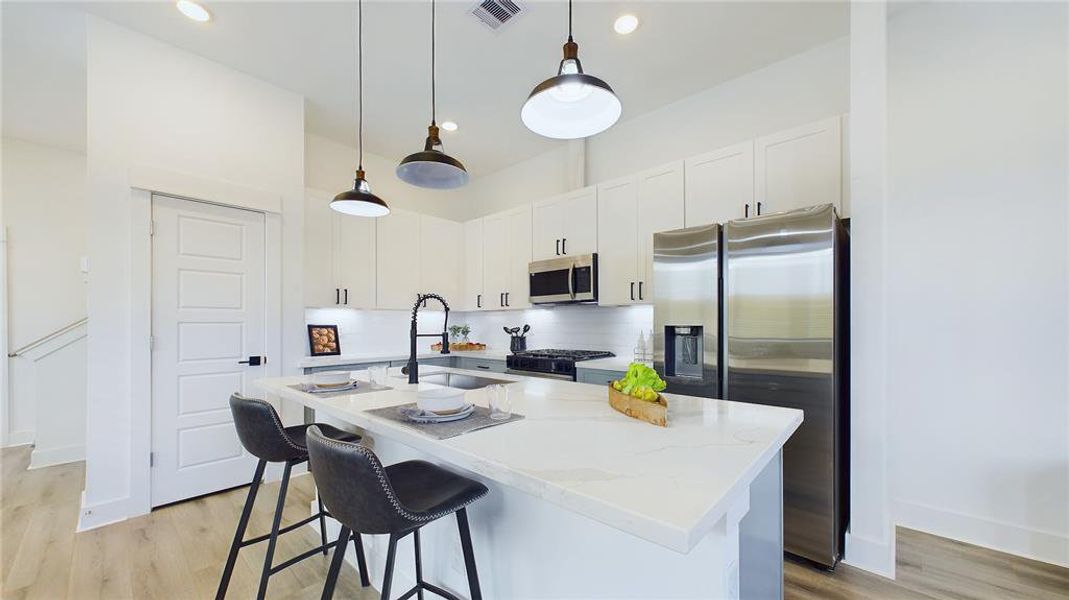 A large kitchen island is perfect for gatherings and food preparation.