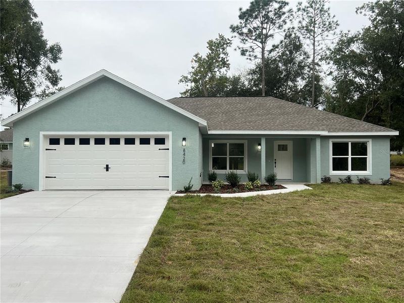 Front exterior of a new home in , Summerfield, FL, highlighting curb appeal (Image 1).