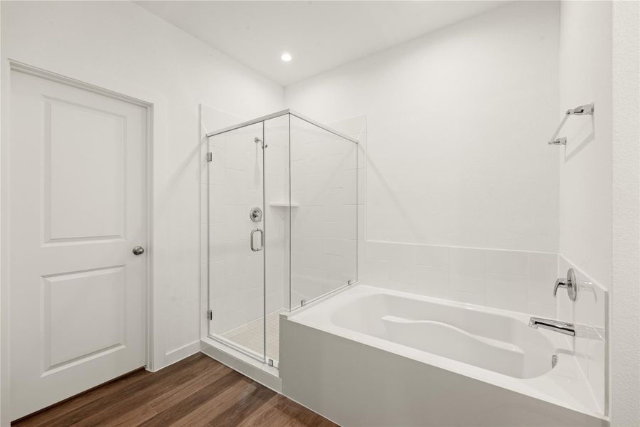 Discover the luxury of this beautifully appointed bathroom, offering the best of both worlds with a contemporary soaking tub and a stand-up glass shower. The clean lines and modern amenities make this a highly desirable feature of the home.