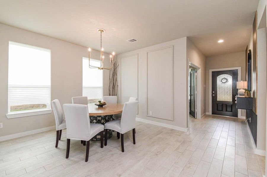 Formal dining w upgrades just past the front entry and office.