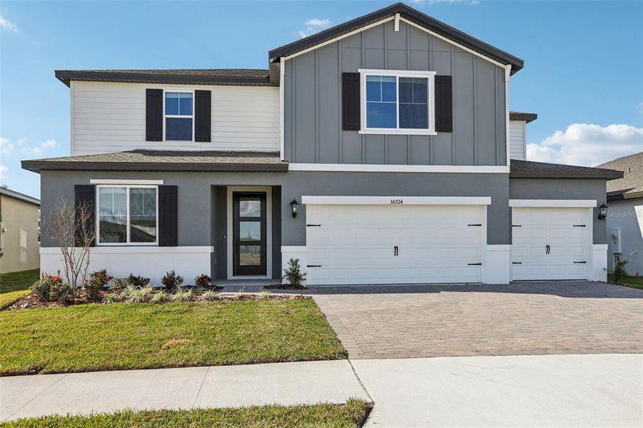 Front exterior of a new home in Two Rivers - Signature Series, Zephyrhills, FL, highlighting curb appeal (Image 25). Front exterior of a new home in Two Rivers - Signature Series, Zephyrhills, FL, highlighting curb appeal (Image 25).