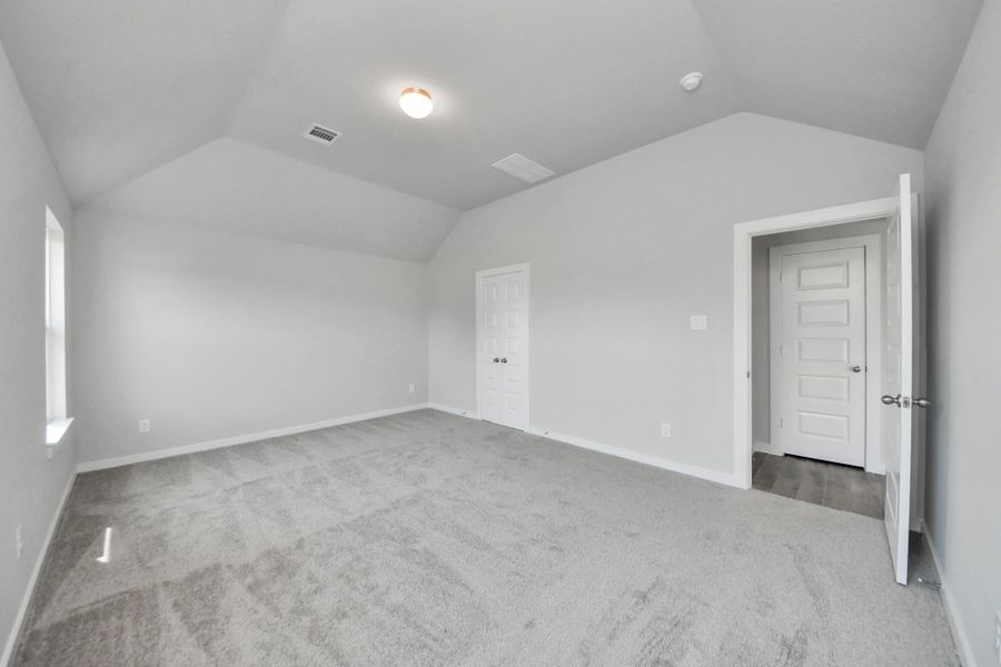 Escape to tranquility in this spacious primary room, adorned with plush carpeting and bathed in the soothing hues of warm paint colors, creating a cozy retreat for relaxation. Sample photo of completed home with similar floor plan. Actual colors and selections may vary. Escape to tranquility in this spacious primary room, adorned with plush carpeting and bathed in the soothing hues of warm paint colors, creating a cozy retreat for relaxation. Sample photo of completed home with similar floor plan. Actual colors and selections may vary.