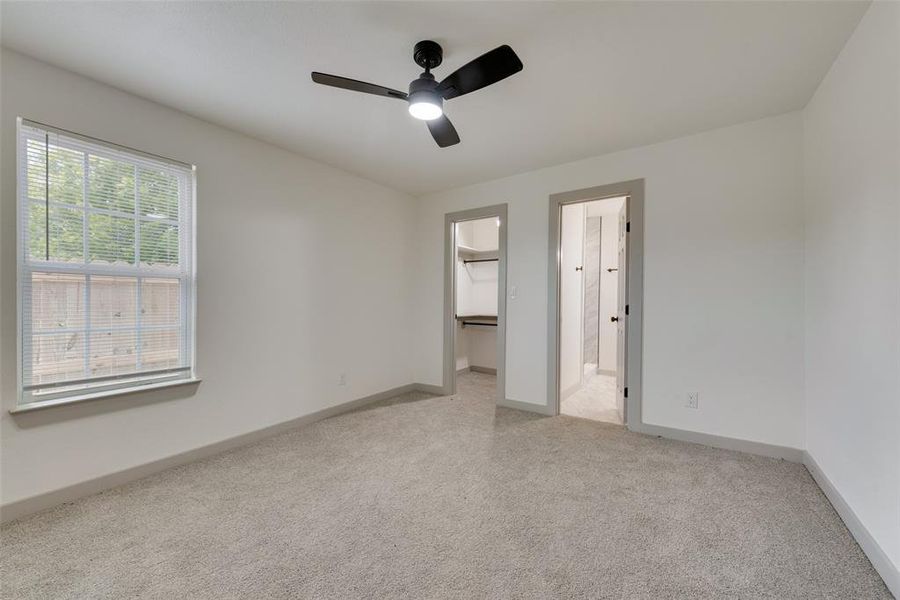 Spare room featuring light colored carpet and ceiling fan