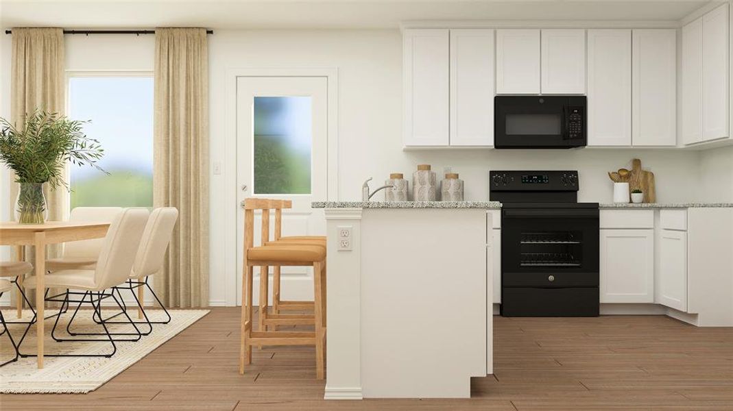 Kitchen featuring black appliances, light stone counters, white cabinets, and light hardwood / wood-style floors