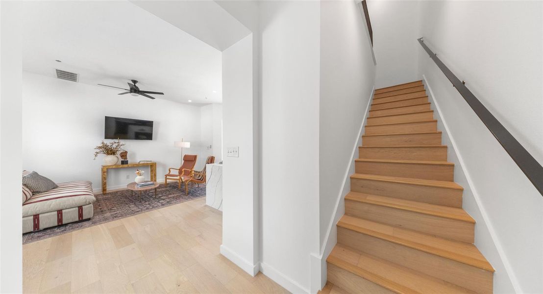A wood-tread staircase with a comfortable landing nook — a thoughtful pause between the home's living levels. Model No. 105 Shown.