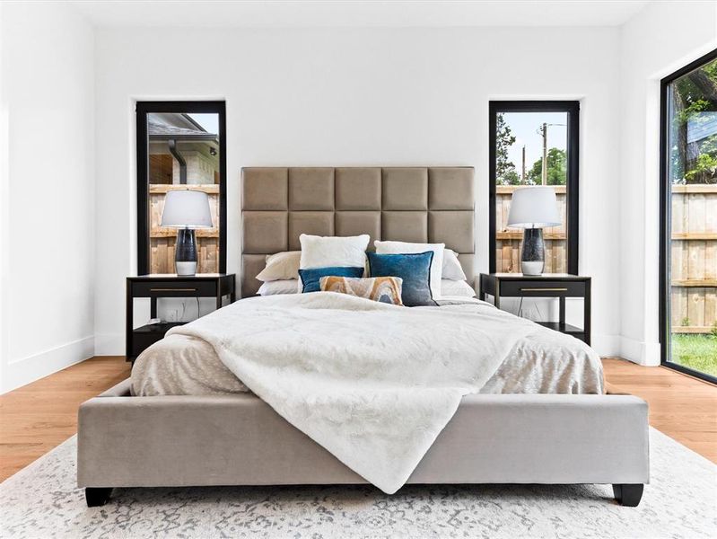 Bedroom with hardwood / wood-style flooring