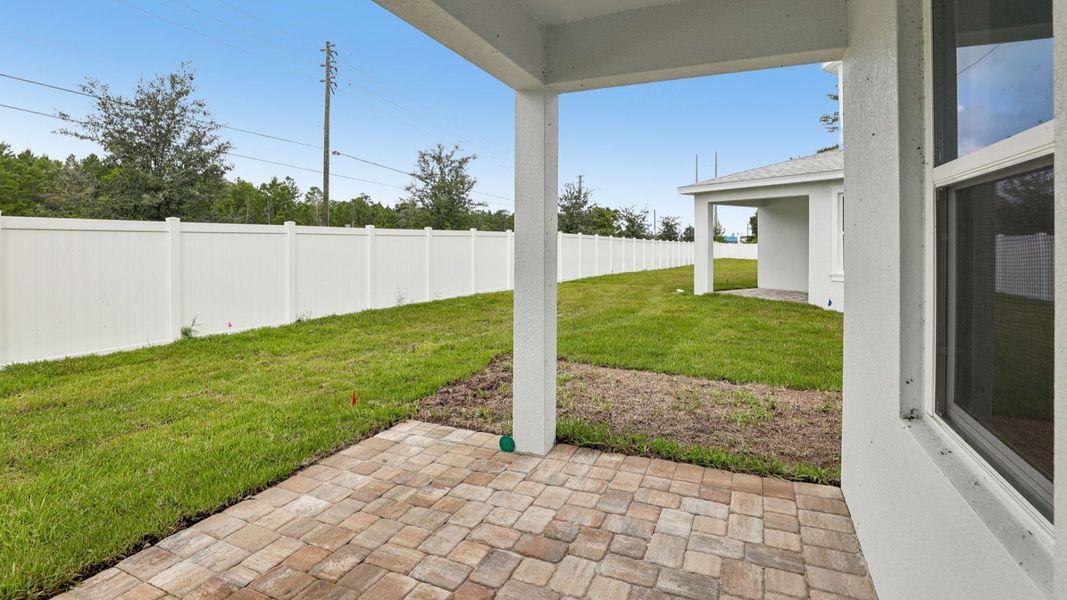 Exterior details and patio area of a home in Cyrene at Harmony, St. Cloud (Image 20).