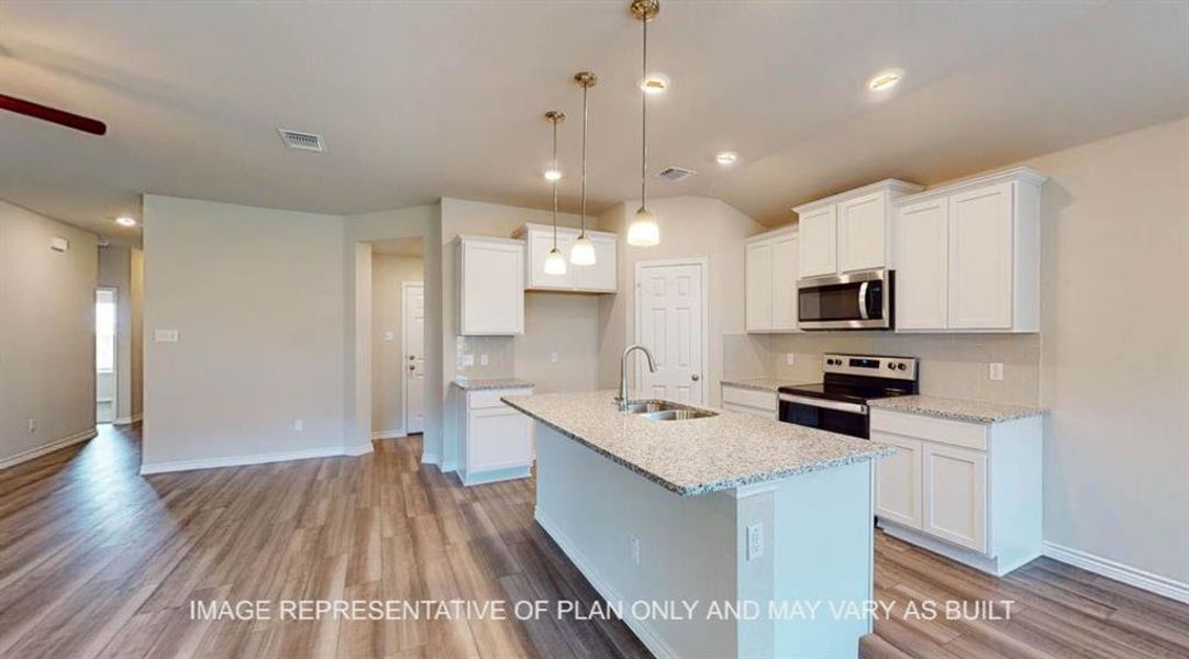 Kitchen featuring white cabinetry, recessed lighting, appliances with stainless steel finishes, light stone counters, and light wood-type flooring Kitchen featuring white cabinetry, recessed lighting, appliances with stainless steel finishes, light stone counters, and light wood-type flooring