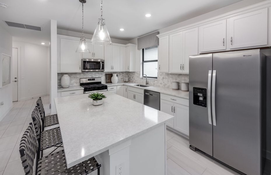 Kitchen with large center island and stainless steel appliances
