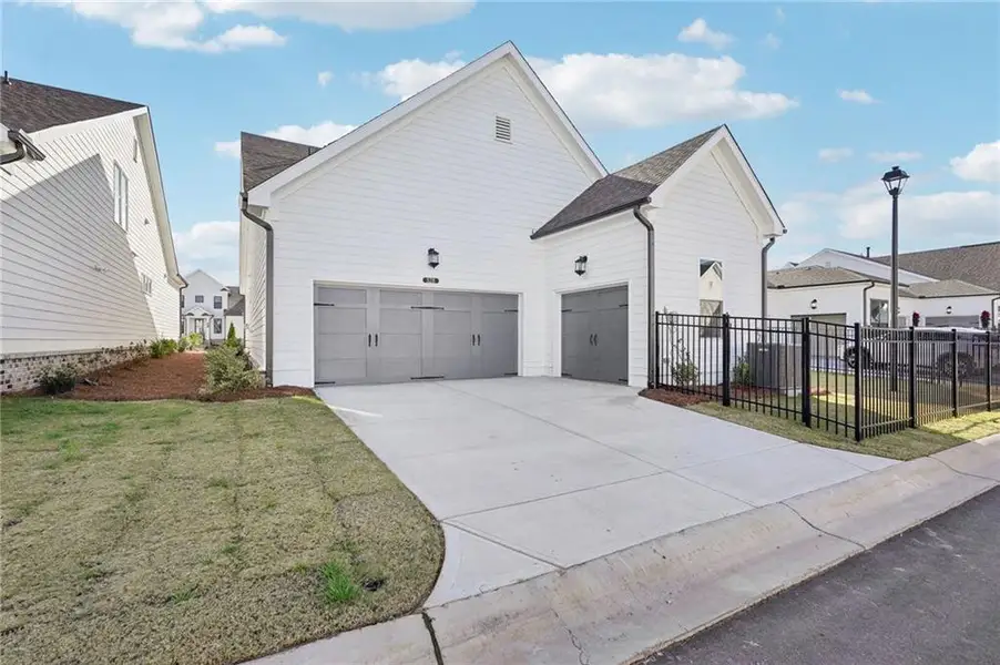 Front exterior of a new home in Promenade at Sawnee Village, Cumming, GA, highlighting curb appeal (Image 2). Front exterior of a new home in Promenade at Sawnee Village, Cumming, GA, highlighting curb appeal (Image 2).