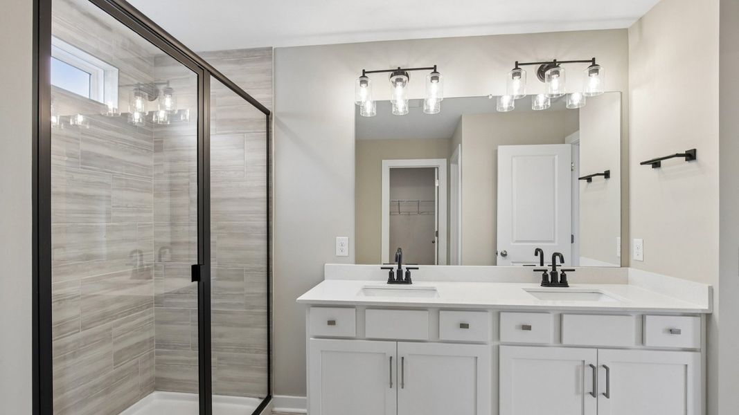 Bathroom with tile shower and glass enclosure, along with dual vanity Bathroom with tile shower and glass enclosure, along with dual vanity
