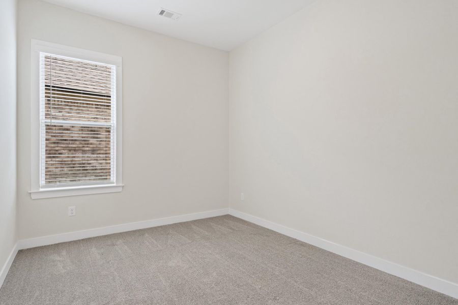Neutral-toned room featuring a single window with blinds, light gray carpet, and white baseboards Neutral-toned room featuring a single window with blinds, light gray carpet, and white baseboards