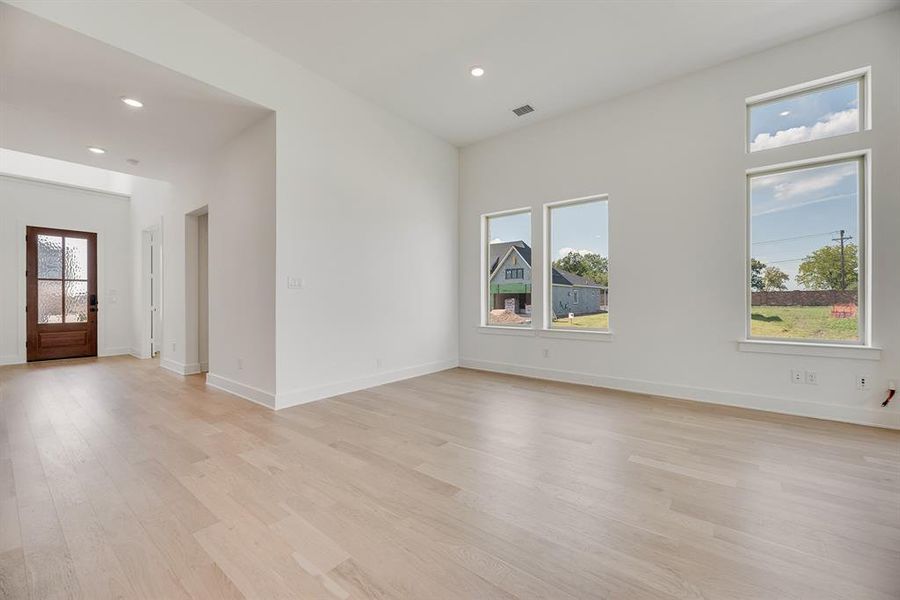 Unfurnished room featuring recessed lighting and light wood-style flooring Unfurnished room featuring recessed lighting and light wood-style flooring