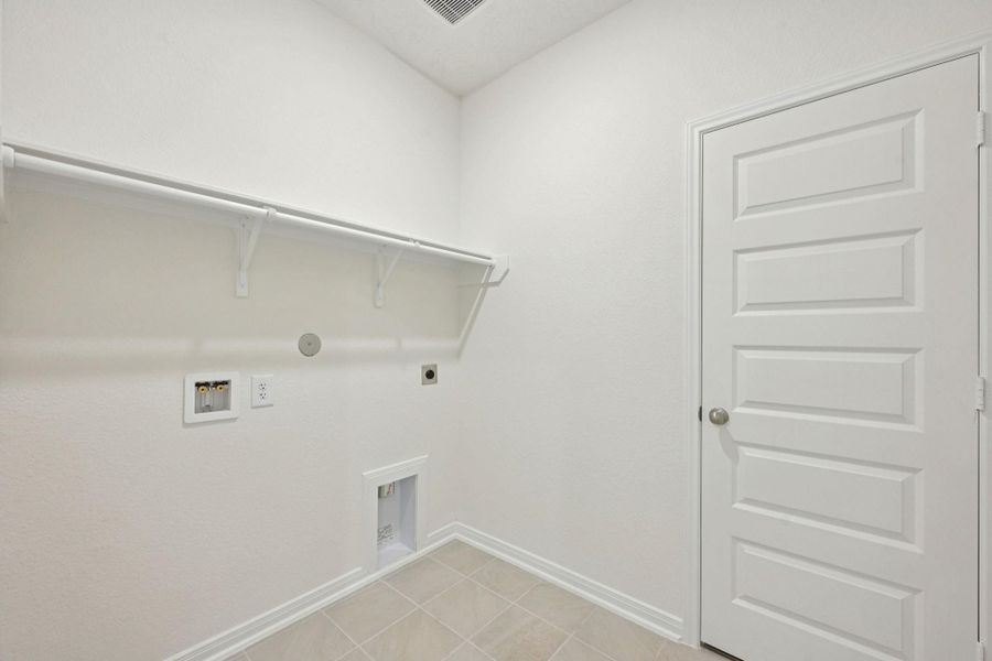 Conveniently located in the middle of the home, this dedicated laundry room simplifies your daily routine by keeping chores exactly where they are needed most.
