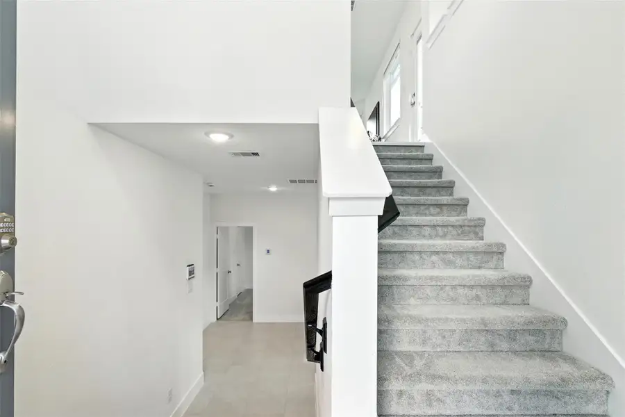 Upon entering is the carpeted staircase to the second floor. Upon entering is the carpeted staircase to the second floor.