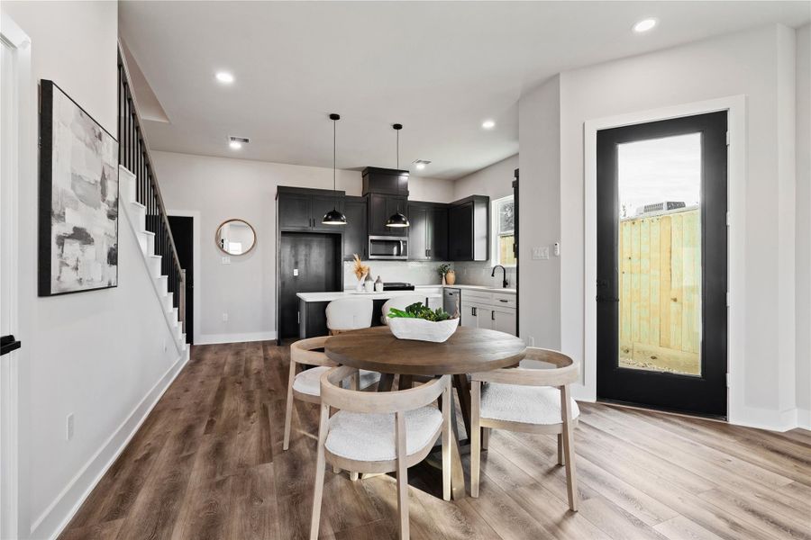 This open-concept layout connects the main living area seamlessly to the kitchen, creating a space that feels both expansive and inviting. With modern finishes and a smooth flow throughout, it’s designed for effortless living and gathering.