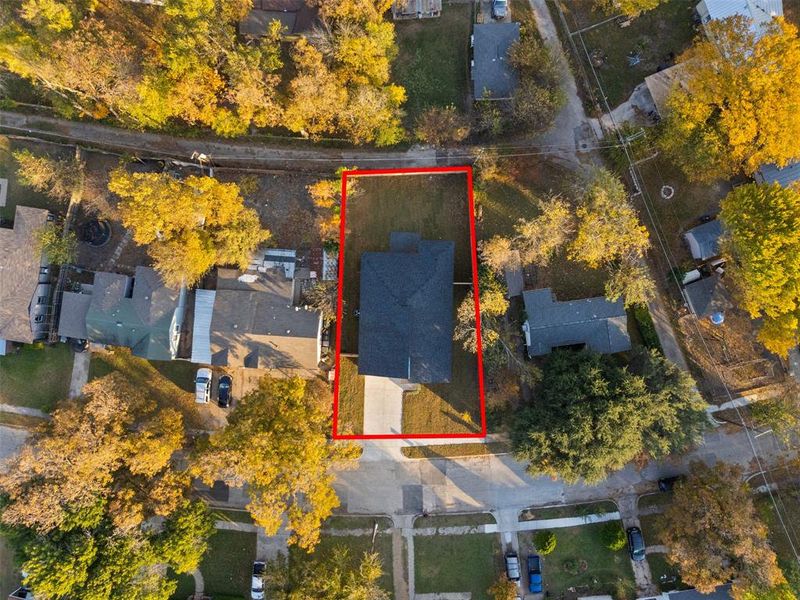 Aerial perspective of suburban area featuring property boundaries highlighted